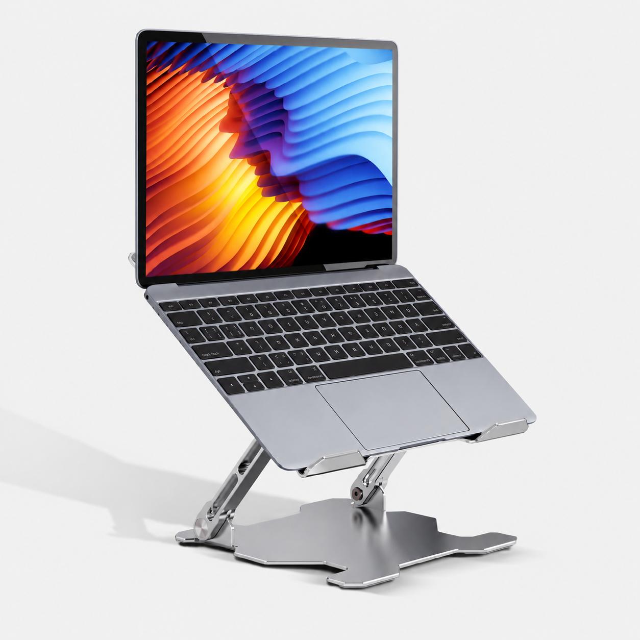 Laptop raised on an aluminium stand on a tidy desk